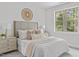 Bright bedroom featuring a woven decor piece, plush bedding and neutral tones complemented by natural light through a large window at 3400 Amelia Grace Dr # 46, Fuquay Varina, NC 27526