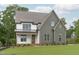 Two-story home featuring mixed siding, a covered porch, and professionally landscaped yard at 3400 Amelia Grace Dr # 46, Fuquay Varina, NC 27526