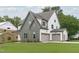 Two-story home with a three-car garage and lush green lawn at 3400 Amelia Grace Dr # 46, Fuquay Varina, NC 27526