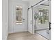 Bright foyer with modern sliding doors and light wood-look floors at 3400 Amelia Grace Dr # 46, Fuquay Varina, NC 27526