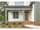 Inviting front porch with craftsman-style columns and landscaped garden at 3400 Amelia Grace Dr # 46, Fuquay Varina, NC 27526