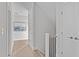 Hallway with wood floors, doors, stairs with black railing, and artwork to add an elegant touch at 3400 Amelia Grace Dr # 46, Fuquay Varina, NC 27526
