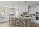 Kitchen island with barstool seating, pendant lights, white cabinets and modern stainless appliances at 3400 Amelia Grace Dr # 46, Fuquay Varina, NC 27526