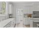 Bright kitchen featuring stainless appliances, granite countertops, white cabinets, and tile backsplash at 3400 Amelia Grace Dr # 46, Fuquay Varina, NC 27526