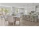 Open-concept kitchen with a large island, breakfast bar, and adjacent dining area filled with sunlight at 3400 Amelia Grace Dr # 46, Fuquay Varina, NC 27526
