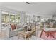 Living room featuring large windows, modern furniture, and access to the outside patio at 3400 Amelia Grace Dr # 46, Fuquay Varina, NC 27526
