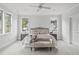 Bright main bedroom with large windows, plush carpet, and elegant furnishings offers a serene retreat at 3400 Amelia Grace Dr # 46, Fuquay Varina, NC 27526