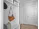 Well-organized mudroom featuring bench, shelving, and hooks, providing a convenient space for storage at 3400 Amelia Grace Dr # 46, Fuquay Varina, NC 27526