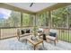 Inviting screened porch with comfortable seating, stylish decor, and views of the surrounding trees at 3400 Amelia Grace Dr # 46, Fuquay Varina, NC 27526