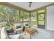 Cozy screened porch with cushioned chairs, decorative pillows, and natural views at 3400 Amelia Grace Dr # 46, Fuquay Varina, NC 27526