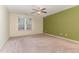 Spacious bedroom with neutral carpeting and a large window at 405 Barewood Dr, Four Oaks, NC 27524