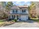 Two-story house with gray siding, a gray roof, and a gravel driveway at 405 Barewood Dr, Four Oaks, NC 27524