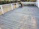 Spacious wooden deck with white railings, grill, and seating area at 4300 Hickory Ridge Dr, Raleigh, NC 27609