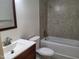 Bathroom featuring a framed mirror, updated vanity, toilet, and bathtub with tiled surround at 4300 Hickory Ridge Dr, Raleigh, NC 27609