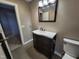 Bathroom featuring a dark wood vanity with white countertop and a framed mirror above the sink at 4300 Hickory Ridge Dr, Raleigh, NC 27609
