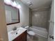 Bathroom featuring a framed mirror, updated vanity, toilet, and bathtub with tiled walls at 4300 Hickory Ridge Dr, Raleigh, NC 27609