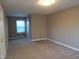 Bedroom showcasing neutral walls, plush carpet, and a window view at 4300 Hickory Ridge Dr, Raleigh, NC 27609