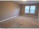 Spacious bedroom featuring neutral carpet, paint, and natural light through two windows at 4300 Hickory Ridge Dr, Raleigh, NC 27609