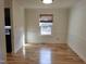 Dining room featuring a large window and hardwood floors at 4300 Hickory Ridge Dr, Raleigh, NC 27609