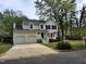 Charming two-story home features a two-car garage, white siding, black shutters, and a landscaped yard at 4300 Hickory Ridge Dr, Raleigh, NC 27609