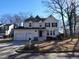 Traditional two-story home features a well-kept front lawn, a driveway, and a three-car garage at 4300 Hickory Ridge Dr, Raleigh, NC 27609