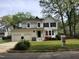 Inviting two-story home with white siding, a two-car garage, and a well-maintained front lawn with 'For Sale' sign at 4300 Hickory Ridge Dr, Raleigh, NC 27609