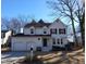 Charming white two-story home with a two-car garage and well-maintained front yard on a sunny day at 4300 Hickory Ridge Dr, Raleigh, NC 27609