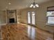 Large open living room with stone fireplace and French doors at 4300 Hickory Ridge Dr, Raleigh, NC 27609