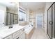 Bright bathroom with a soaking tub, double vanity sinks, and glass shower enclosure at 4538 Brighton Ridge Dr, Apex, NC 27539