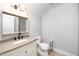 Modern bathroom featuring a granite countertop, decorative mirror, and sleek fixtures, offering a spa-like experience at 4538 Brighton Ridge Dr, Apex, NC 27539