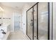 Bathroom featuring tiled glass shower, tile floors, and a vanity sink with bronze hardware at 4538 Brighton Ridge Dr, Apex, NC 27539