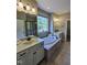Bright bathroom features a large soaking tub, dual vanities and walk-in shower at 4538 Brighton Ridge Dr, Apex, NC 27539