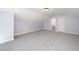 Spacious bonus room featuring neutral walls and carpet, offering a versatile space for various activities and uses at 4538 Brighton Ridge Dr, Apex, NC 27539