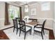Bright dining room with a decorative chandelier, white rug, and wooden dining table at 4538 Brighton Ridge Dr, Apex, NC 27539