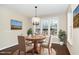 Cozy dining room with hardwood floors, a view of backyard, and decorative rug at 4538 Brighton Ridge Dr, Apex, NC 27539