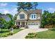 Inviting two-story home featuring a well-maintained lawn and attached garage at 4538 Brighton Ridge Dr, Apex, NC 27539