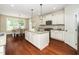 Bright and airy kitchen featuring white cabinets, granite countertops, and stainless steel appliances at 4538 Brighton Ridge Dr, Apex, NC 27539