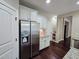 View of the kitchen with stainless steel refrigerator and white cabinets at 4538 Brighton Ridge Dr, Apex, NC 27539