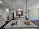 Open kitchen design featuring granite counters, hardwood floors, and an adjoining living area at 4538 Brighton Ridge Dr, Apex, NC 27539