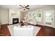 Bright living room with a cozy fireplace and large windows, perfect for entertaining guests at 4538 Brighton Ridge Dr, Apex, NC 27539