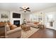 Comfortable living room with a fireplace, neutral furniture, and large windows for natural light at 4538 Brighton Ridge Dr, Apex, NC 27539
