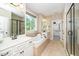 Luxurious bathroom with double vanity, soaking tub, shower, and a walk-in closet at 4538 Brighton Ridge Dr, Apex, NC 27539
