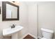 Stylish powder room with pedestal sink and decorative mirror at 4538 Brighton Ridge Dr, Apex, NC 27539