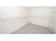 Walk-in closet featuring metal shelving and neutral carpeting at 4538 Brighton Ridge Dr, Apex, NC 27539
