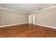 Hardwood floor bedroom with access to hallway at 5 Bee Hill Pl, Durham, NC 27705