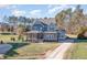 Two-story house with gray siding, stone accents, and a landscaped lawn at 5 Bee Hill Pl, Durham, NC 27705