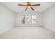 Bright bedroom featuring carpet, ceiling fan, and large windows at 5 Teahouse Ct, Durham, NC 27707