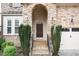 Elegant house entrance with a stone archway and dark brown door at 5 Teahouse Ct, Durham, NC 27707