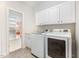 Laundry room with washer, dryer, and white cabinets at 5 Teahouse Ct, Durham, NC 27707