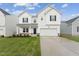Two-story white house with dark gray accents and a grassy lawn at 513 Marthas View Way, Wake Forest, NC 27587